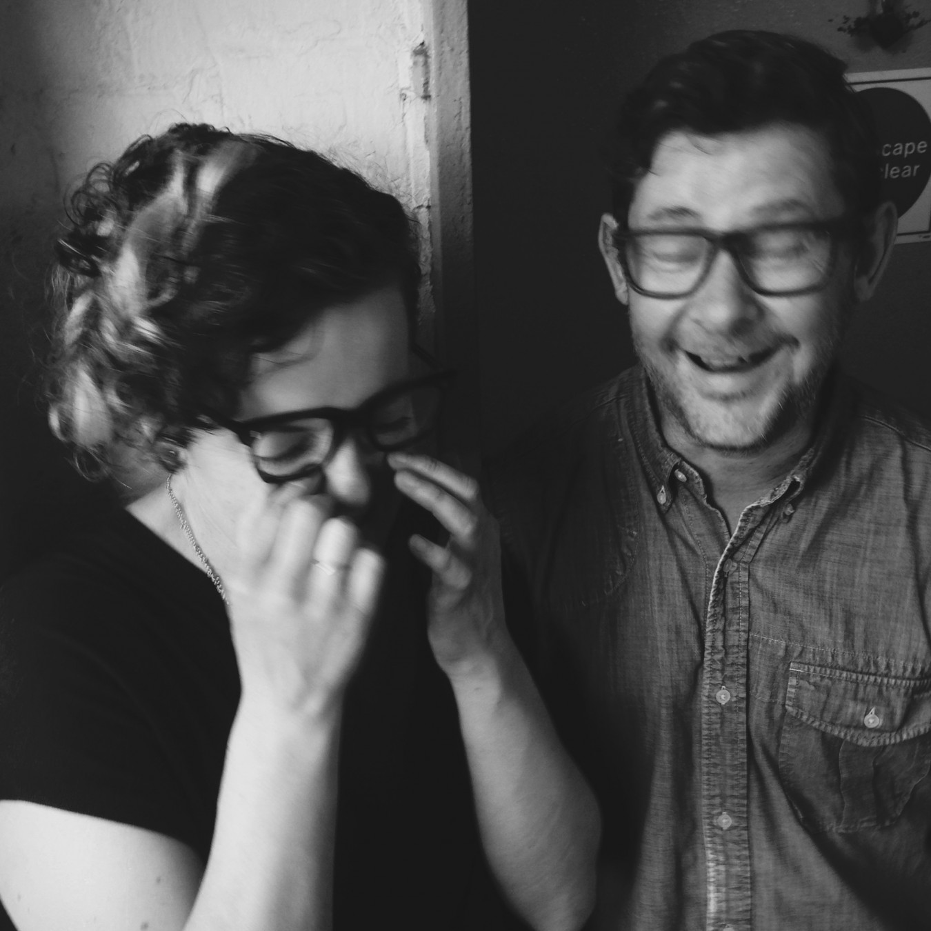 Portrait of Tracey Rowledge and David Clarke laughing to much during a photo shoot