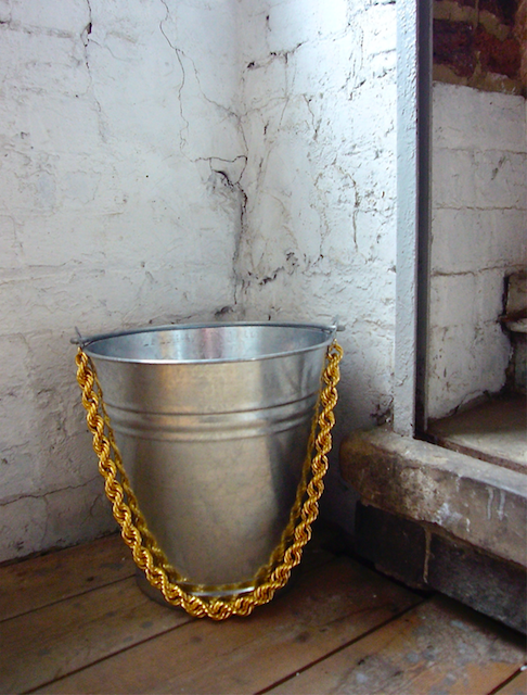 Image of a classic tin bucket with an attached gold bulcher chain.