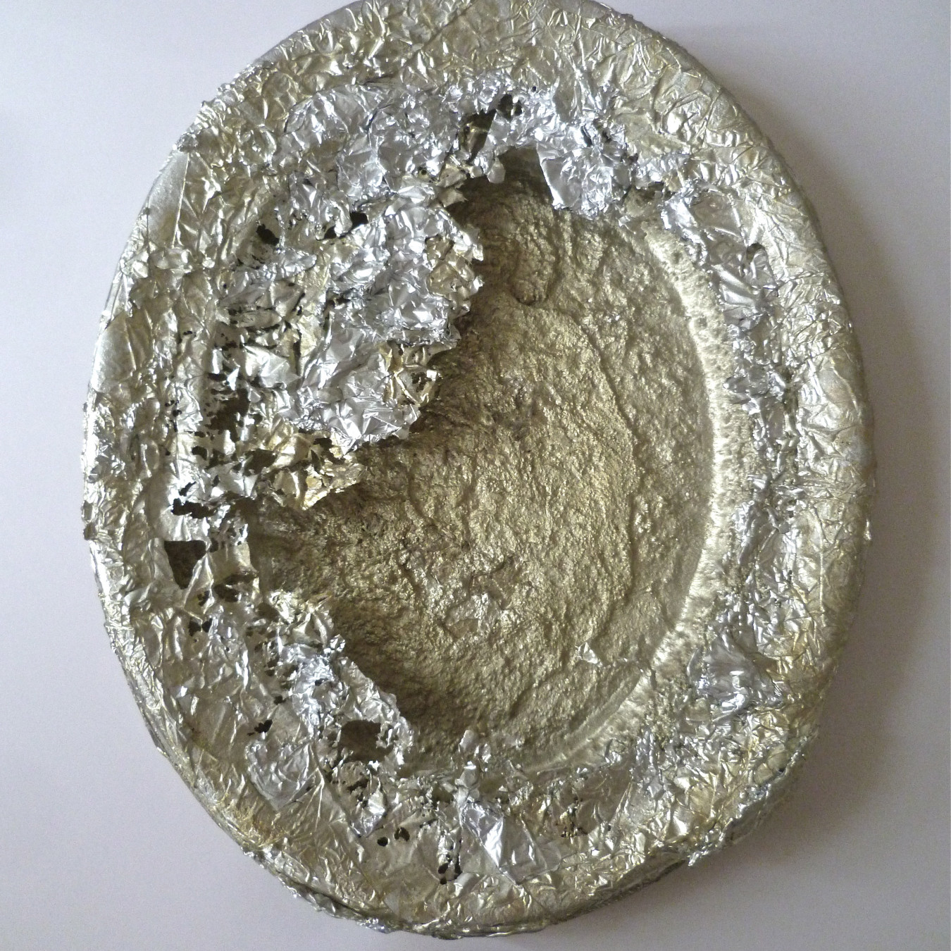Image of a large cast pewter serving dish, the mould is made of aluminium foil