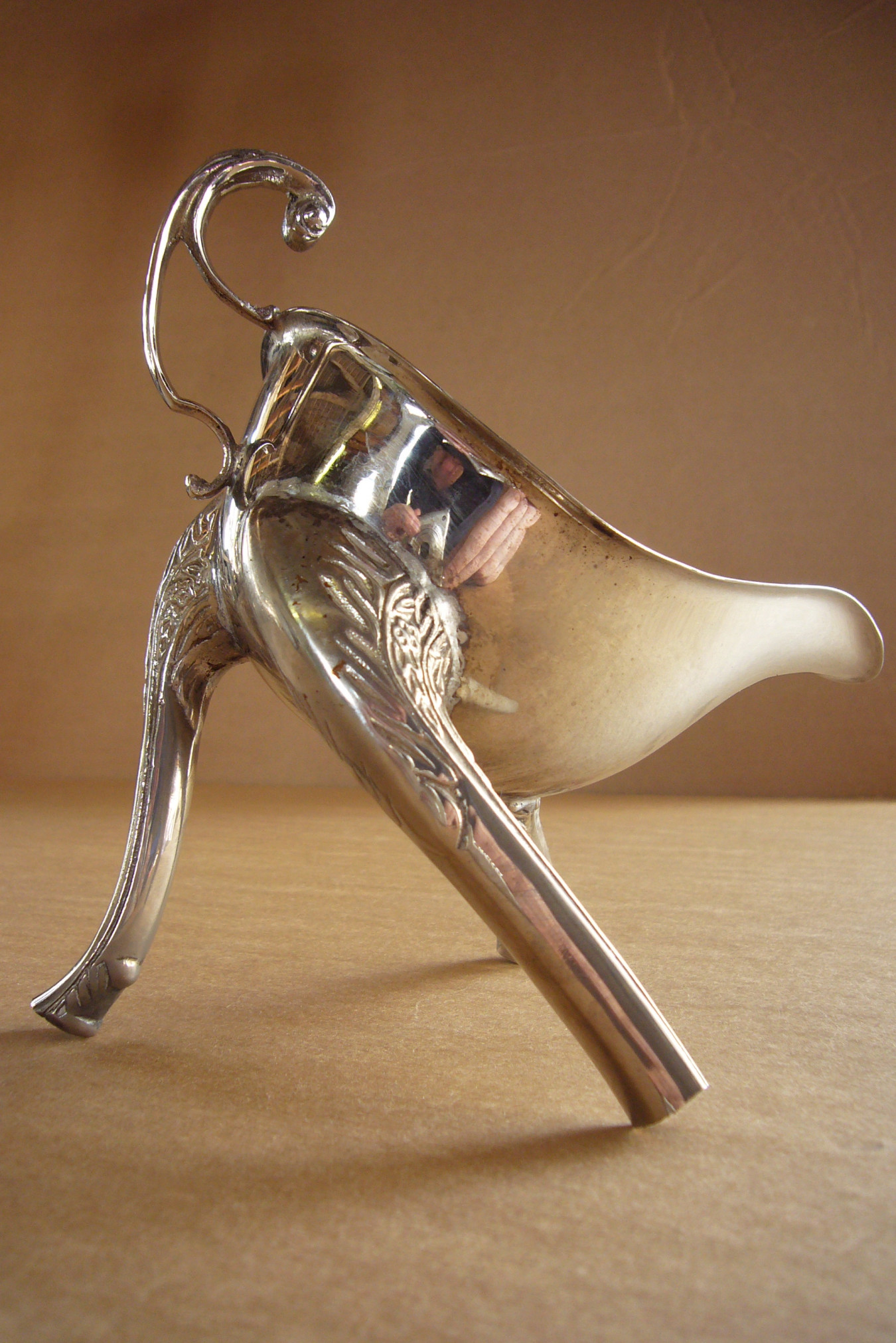 Image of a gravy boat with 3 spouts added for legs to create a monster for the table