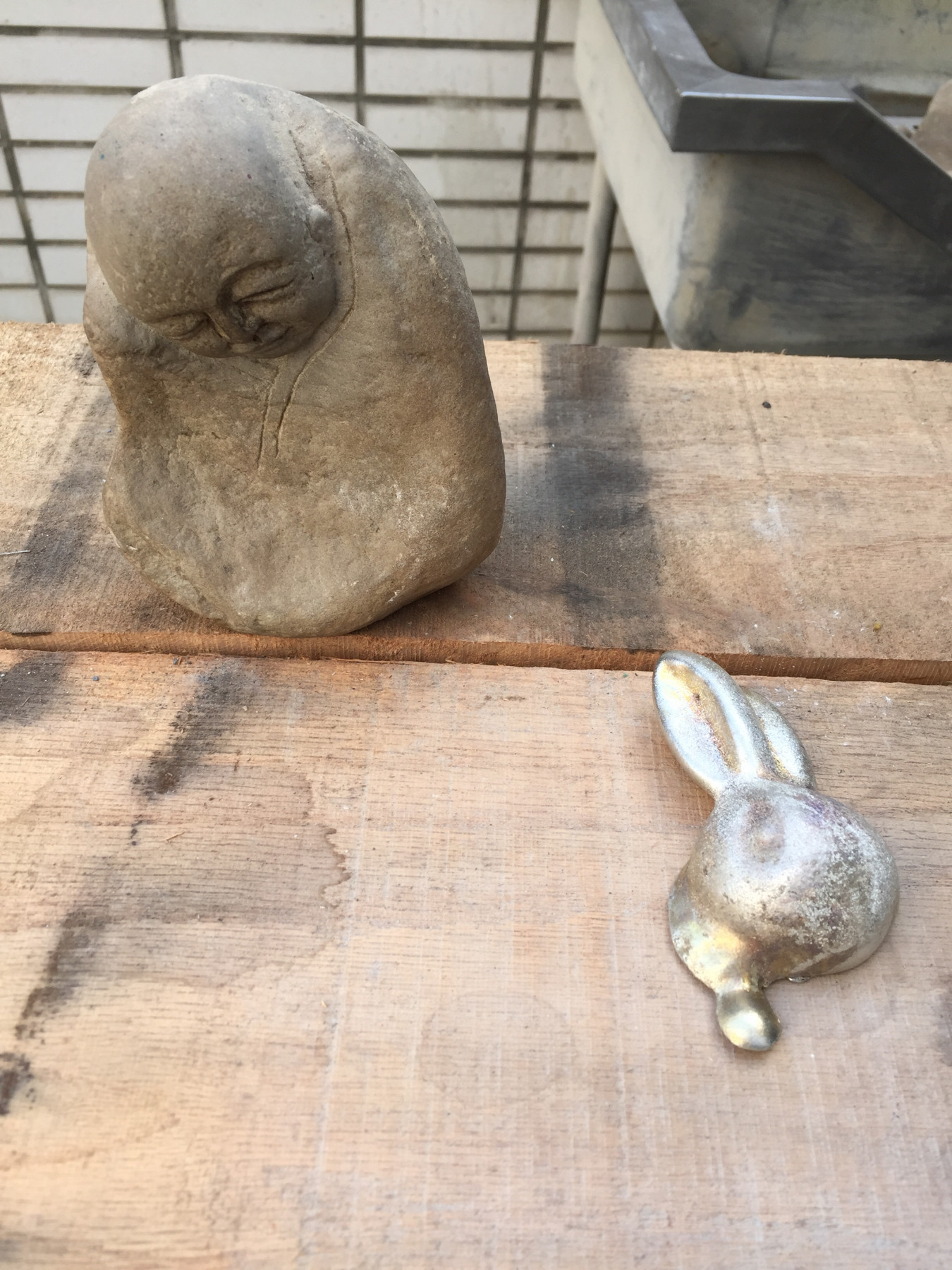 Image of a stone staute made by A-Fu and a pewter bunny by David Clarke. These become material for the other artist.